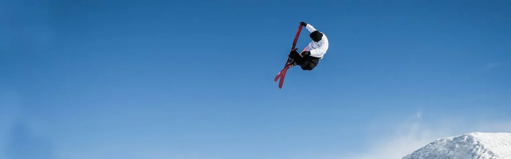 Skier performs aerial trick against clear sky